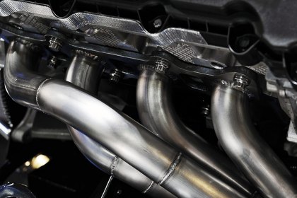 Why Do Some Replacement Exhaust Manifolds Come With Catalytic Converters?