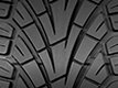 V-shaped directional tread with grooves for better wet traction