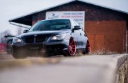 Custom Red JR Wheels As a Focal Point on Black BMW 5-Series