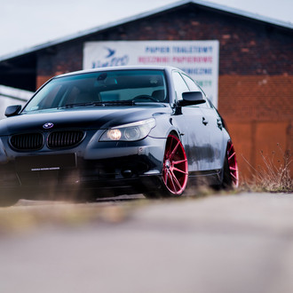 Custom Red JR Wheels As a Focal Point on Black BMW 5-Series