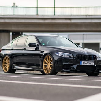 Black BMW 5-Series with Custom Front Bumper - Photo by Vossen