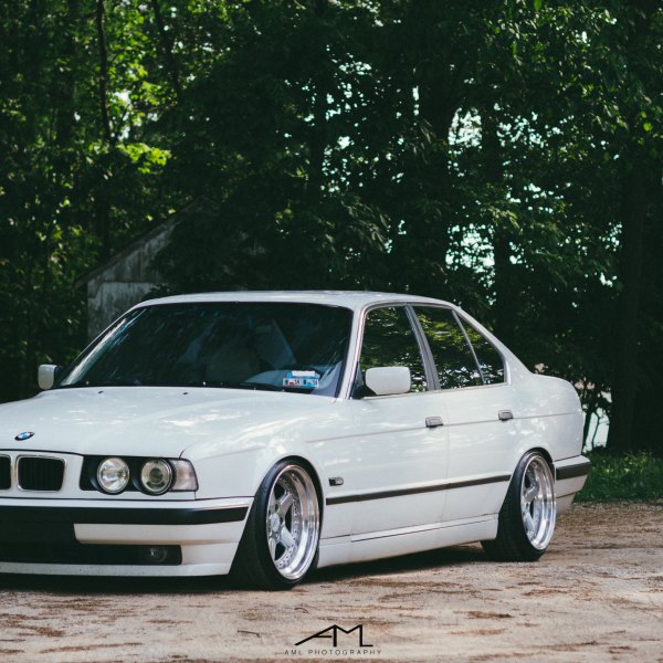 White Lowered BMW 5-Series with Aftermarket Front Bumper - Photo by Arlen Liverman