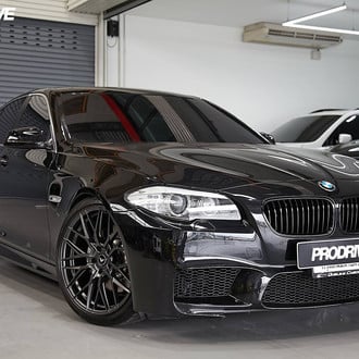 Black BMW 5-Series with Crystal Clear Headlights  - Photo by Vorstiner