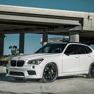 White BMW X1 with Carbon Fiber Front Lip - Photo by Velgen