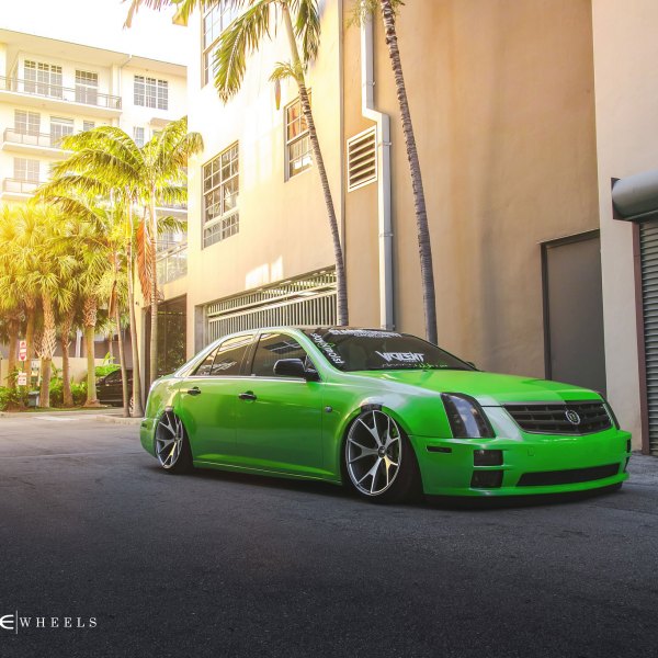 Green Lowered Cadillac STS with Dark Smoke Headlights - Photo by Concept One
