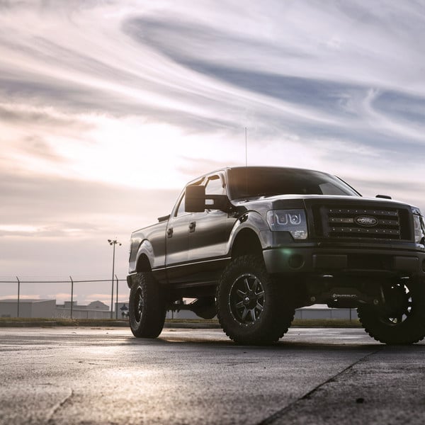 Black Lifted Ford F-150 with LED-Bar Style Headlights - Photo by Fuel Offroad