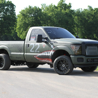 Green Lifted Ford F-250 with Aftermarket Dark Smoke Headlights - Photo by Adam Dobbs