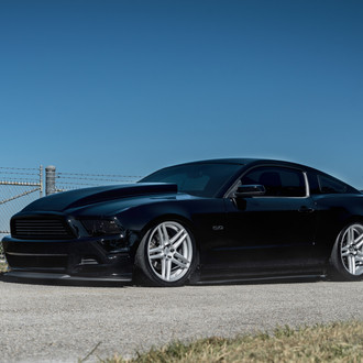Black Ford Mustang 5.0 with Aftermarket Hood - Photo by Velgen