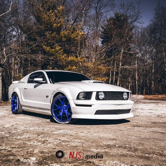 Clean White Mustang GT with 4.6L V8 on Bright Blue Wheels - Photo by Concept One
