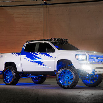 Mall Crawler White Lifted GMC Sierra Rocking Blue Grid Off-Road Rims