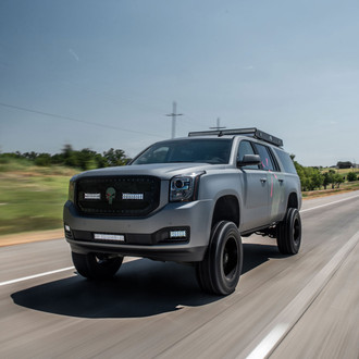Off-road Modified GMC Yukon XL with Mud Tires and Roof Rack - Photo by Complete Customs