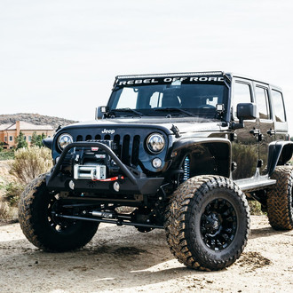 Black Lifted Jeep Wrangler Enhanced with Poison Spyder Running Boards