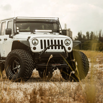 Super Clean JK with Cut-out Aluminum Fenders and Stinger Bumper on 37s - Photo by Vossen