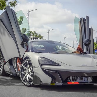 Gray McLaren 570S with Custom Vertical Doors - Photo by Forgiato