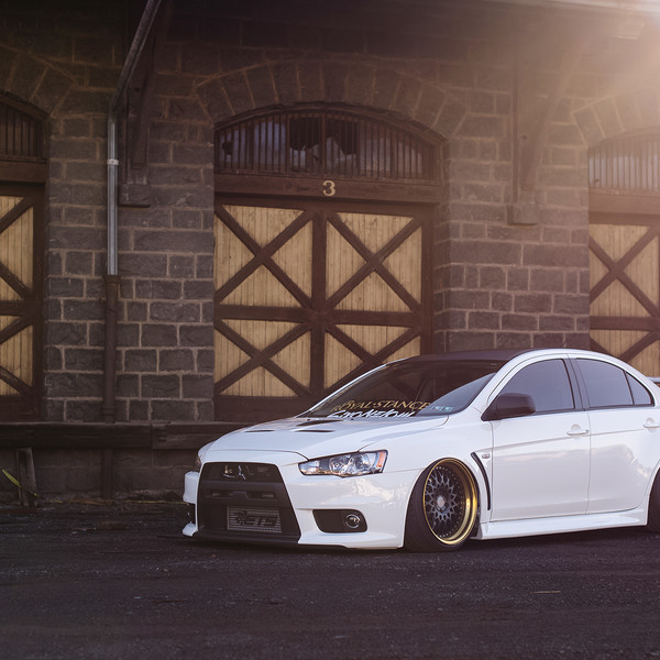 White Stanced Mitsubishi Evolution with Custom Hood - Photo by Avant Garde Wheels