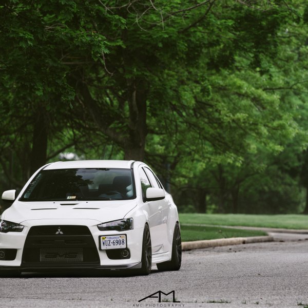 White Mitsubishi Evolution with Dark Smoke Headlights - Photo by Arlen Liverman
