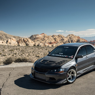Gray Mitsubishi Evolution Showing Off Chrome Rims Featuring Brembo Brakes