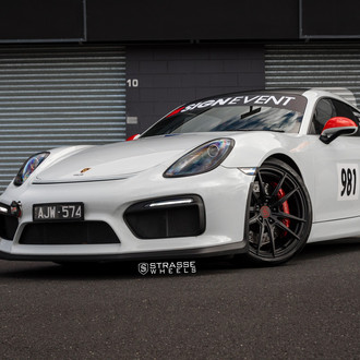 White Debadged Porsche Cayman with Custom Headlights - Photo by Strasse Forged
