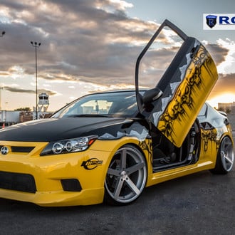 Yellow Scion TC with Custom Graphics and Lambo Doors - Photo by Rohana Wheels