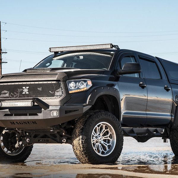 Lifted Toyota Tundra with a Camper Shell - Photo by Grid Off-road