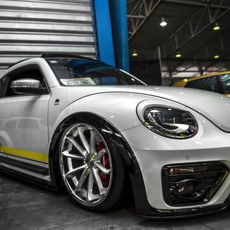 Customized to Impress: White Volkswagen Beetle Dressed in Aftermarket Parts