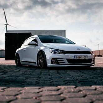 White VW Scirocco with Aftermarket Headlights - Photo by Niche Road Wheels