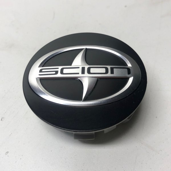 Replikaz® - Black Wheel Center Cap With Embossed Scion Logo